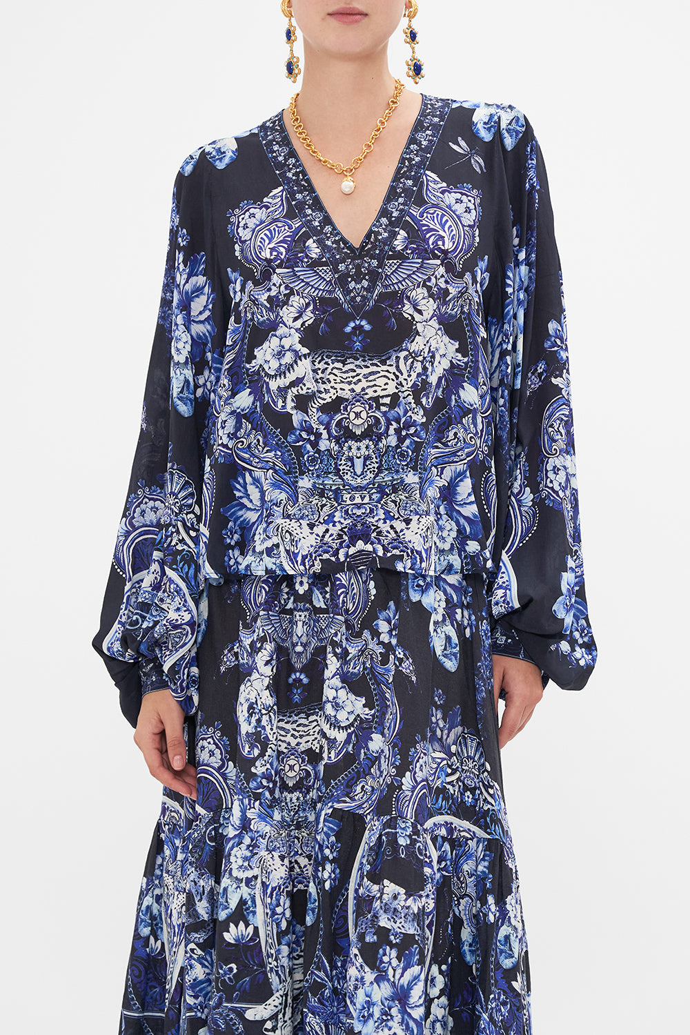 Side view of model wearing CAMILLA silk blouse in Delft Dynasty print