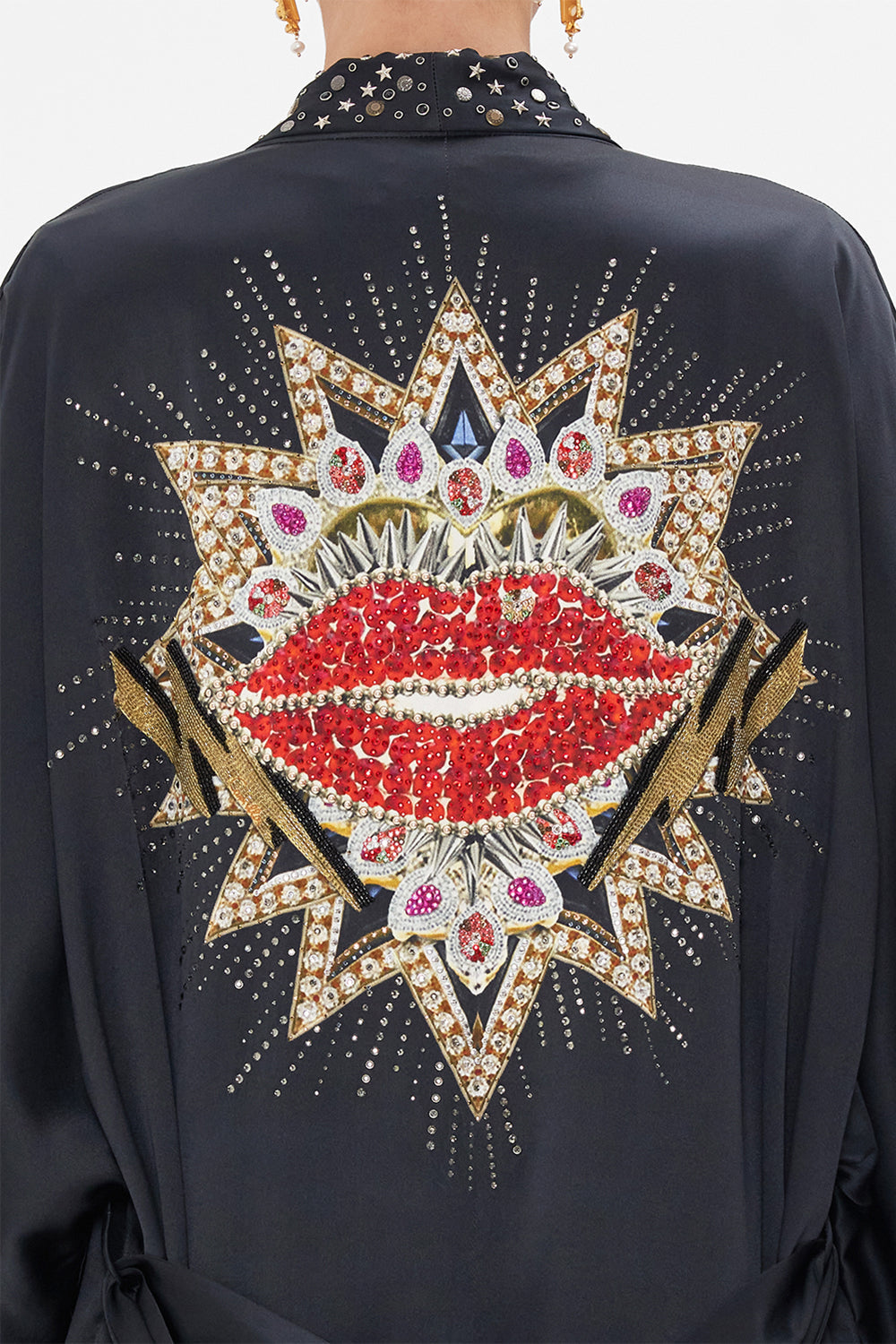 Detail view of model wearing CAMILLA black silk robe in Radical Rebirth print