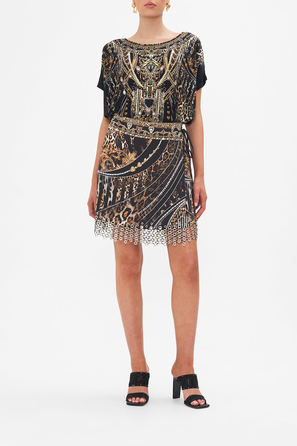Front view of model wearing CAMILLA embellished mini skirt in Chaos In The Cosmos animal print