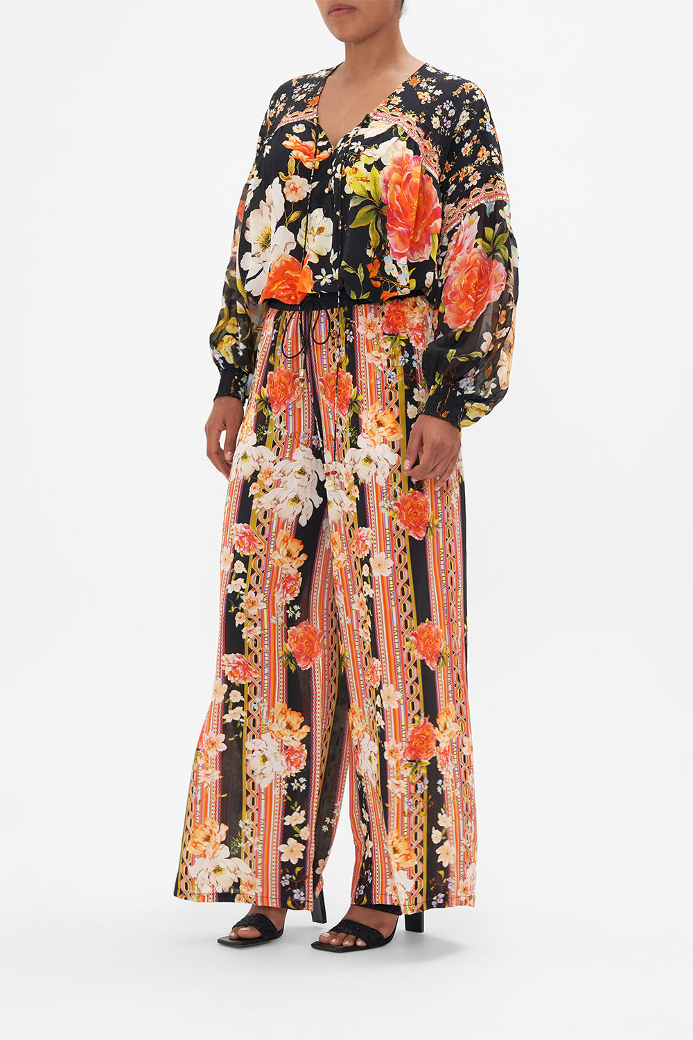 Side view of model wearing CAMILLA silk blouse in the Secret History print