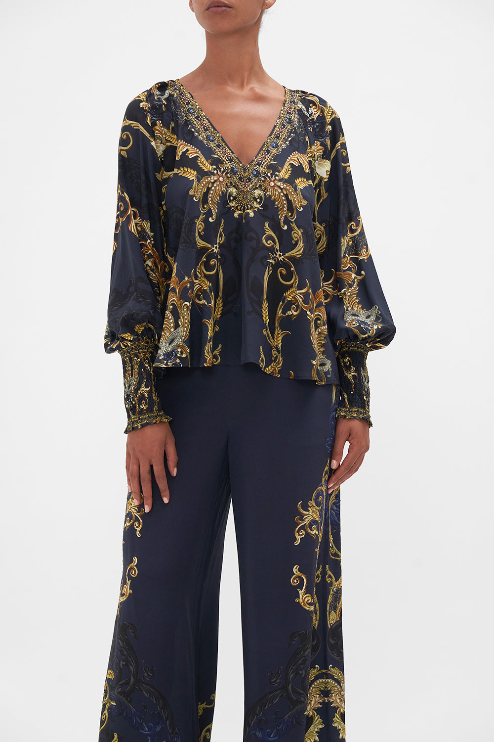 Crop view of model wearing CAMILLA navy silk blouse in Moonlight Melodies print