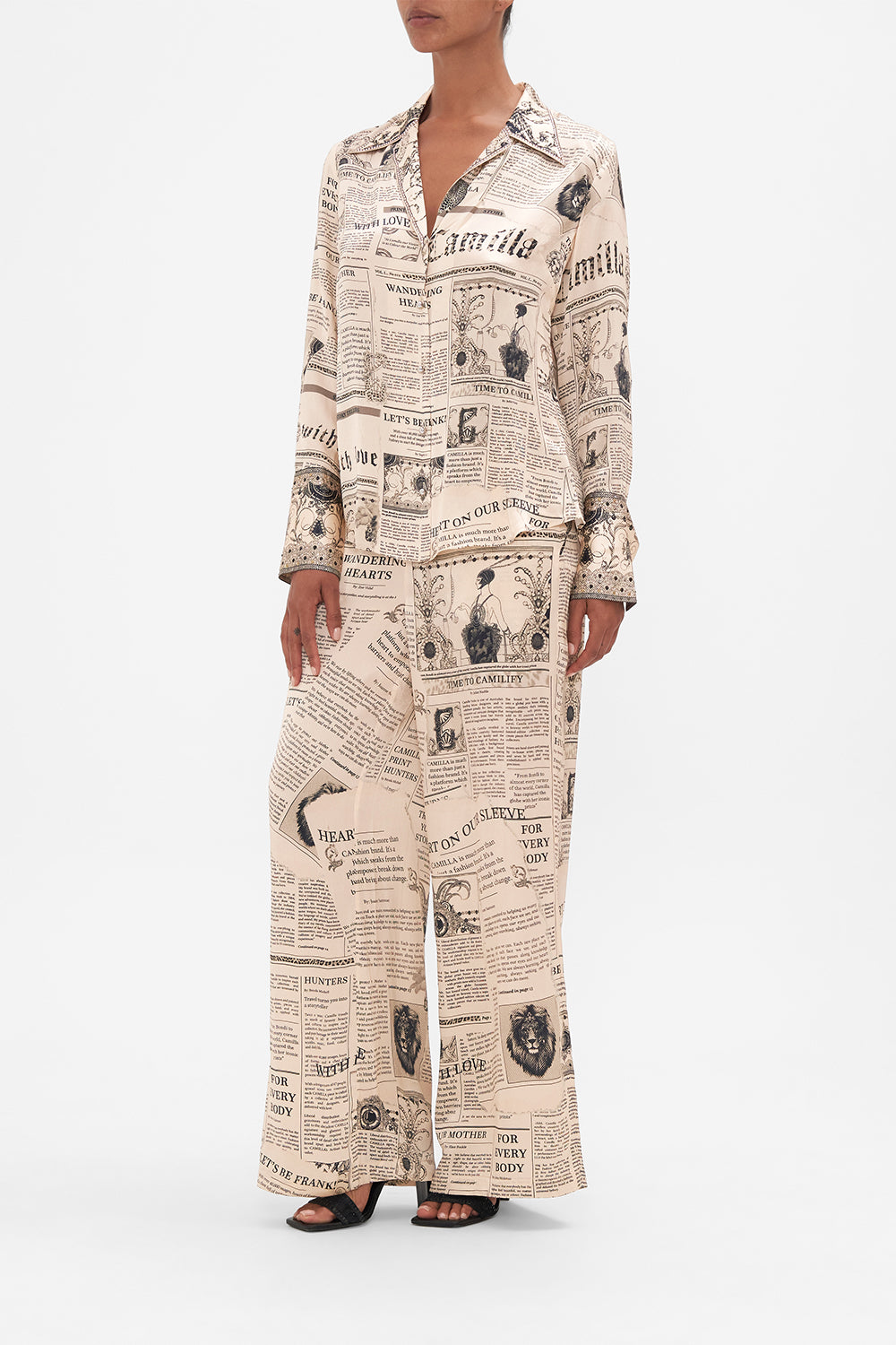 Side view of model wearing CAMILLA pink silk pyjama shirt in Fame Fever print