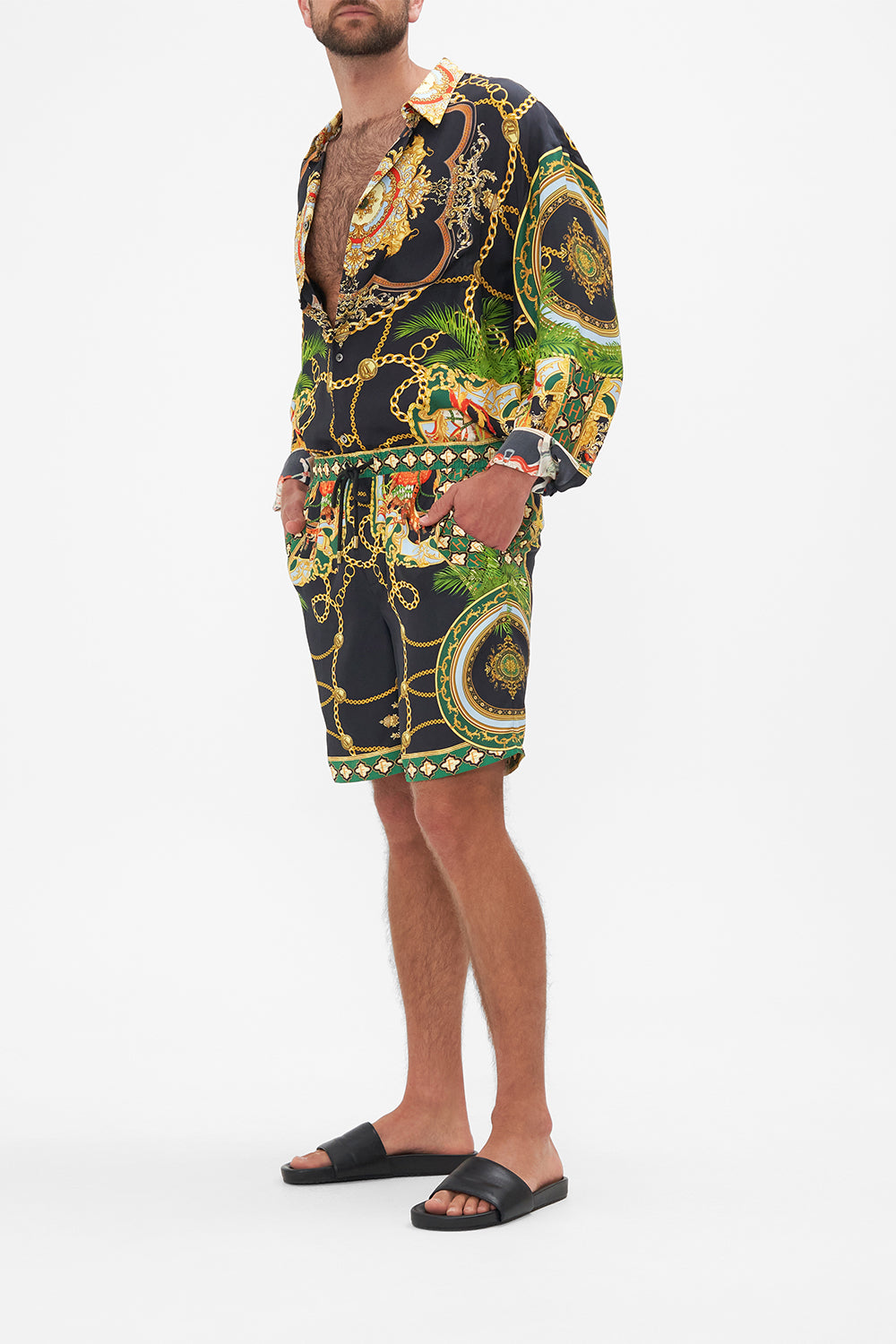 Side view of model wearing Hotel Franks By CAMILLA mens walkshorts in Jealousy And Jewels print