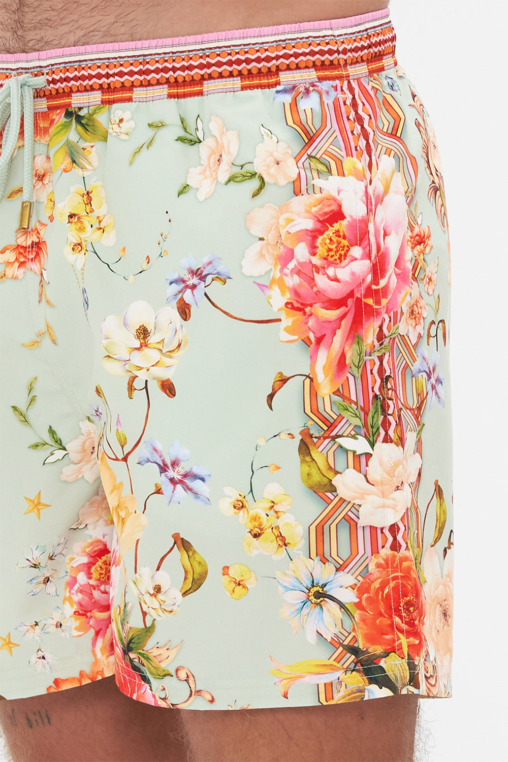 Detail view of model wearing Hotel Franks by CAMILLA mens floral print boardshorts in Talk The Walk print