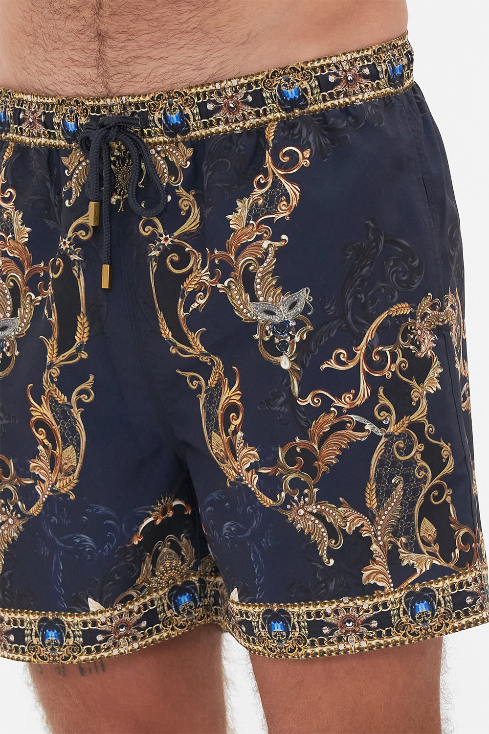 Detail view of model wearing Hotel Franks by CAMILLA mens navy boardshorts in Moonlight Melodies print