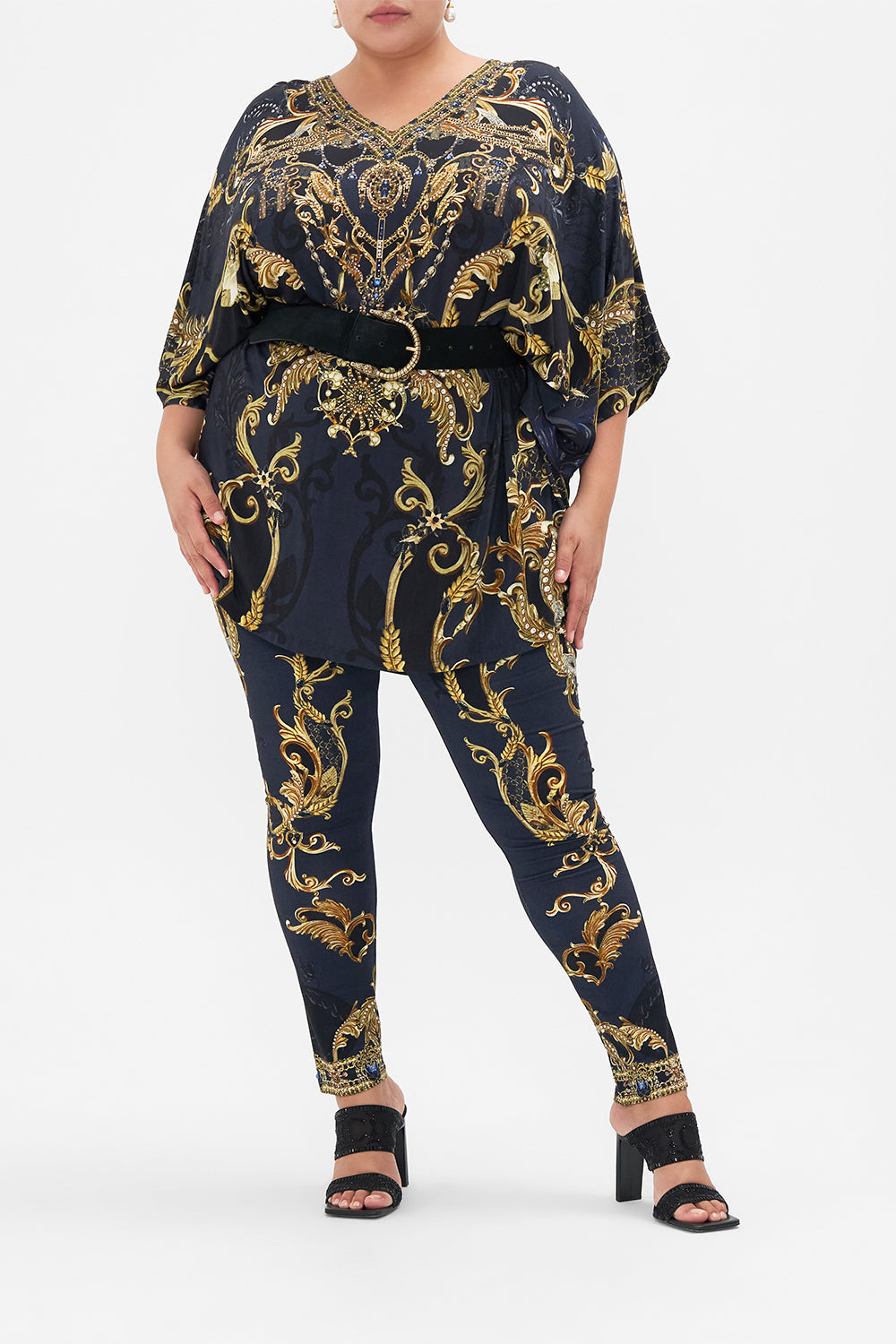 Front view if curvy model wearing CAMILLA plus size leggings in Moonlight Melodies print