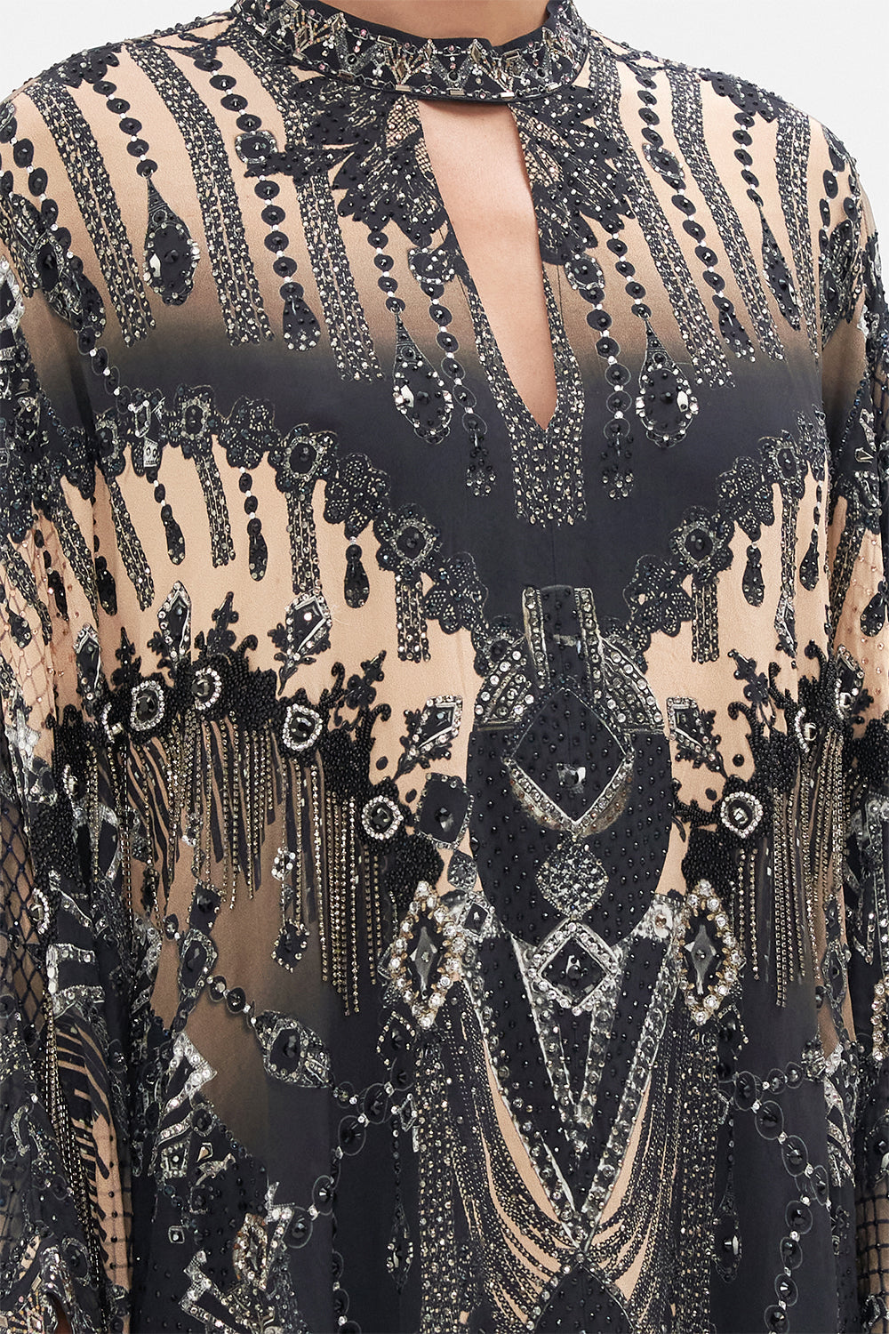 Detail view of model wearing CAMILLA silk kaftan in Curtain Call Chaos print