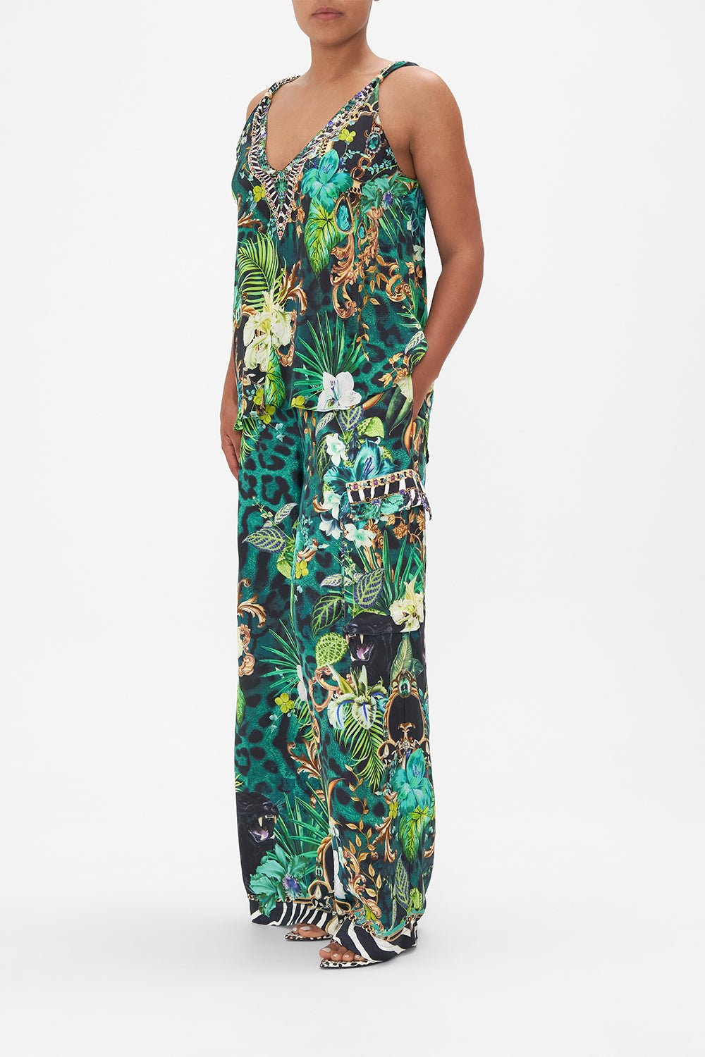 Side view of model wearing CAMILLA green silk tank top in Sing My Song print