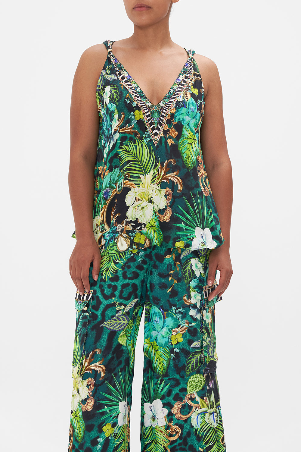 Crop view of model wearing CAMILLA green silk tank top in Sing My Song print