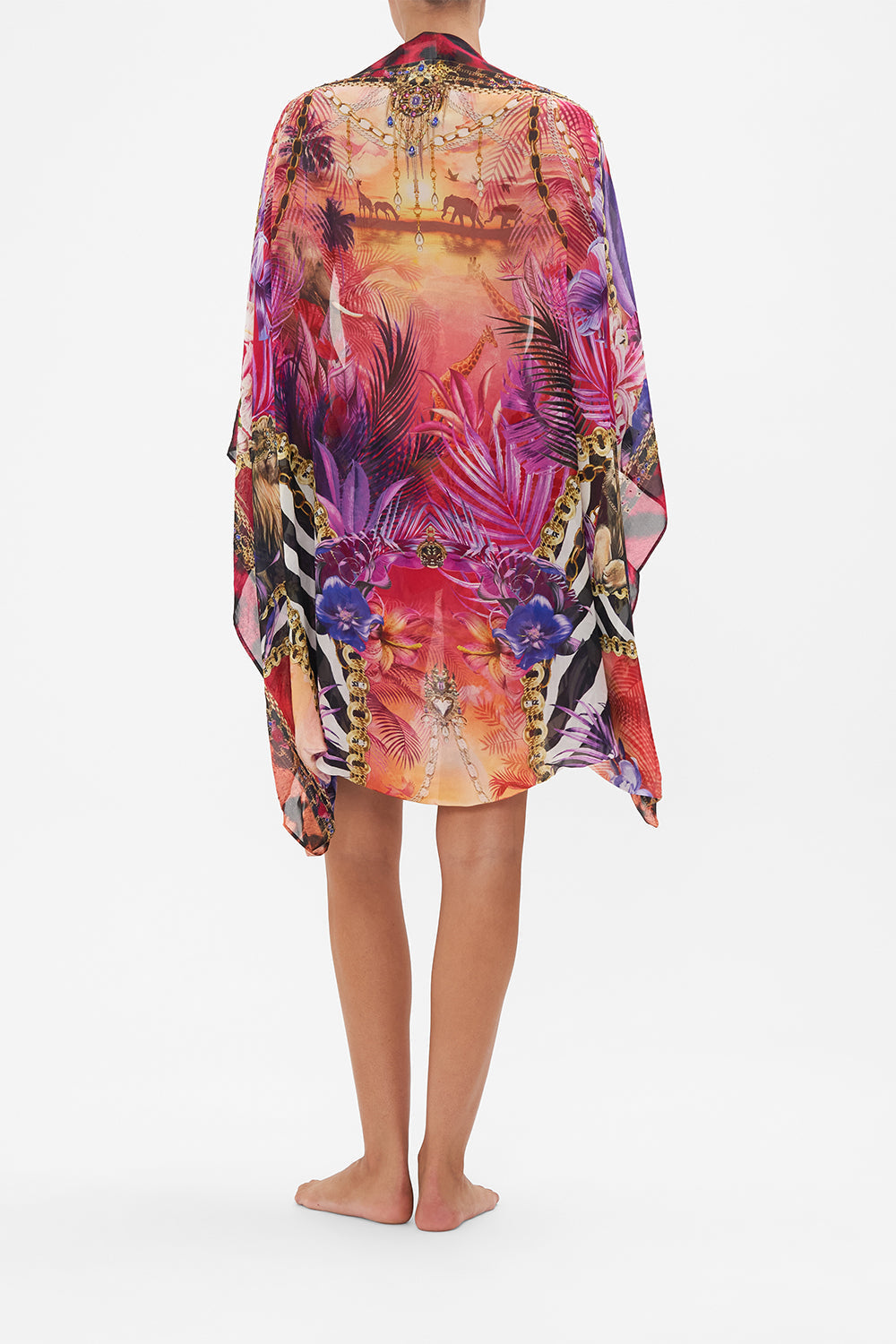 Back view of model wearing CAMILLA silk shrug in mulitcoloured Wild Loving print