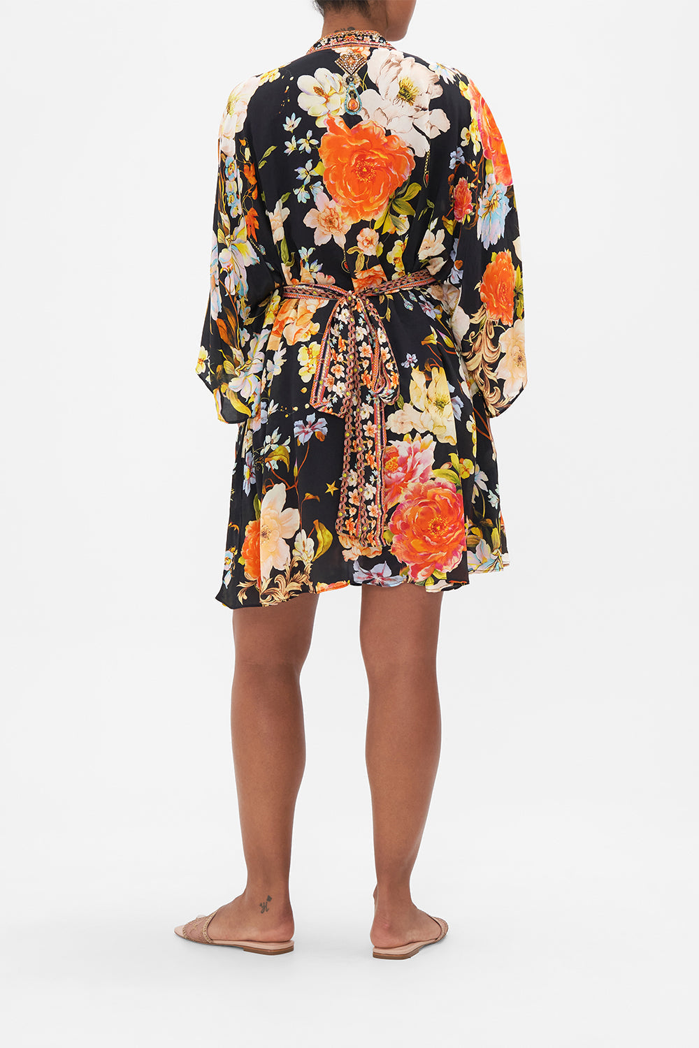 Back view of model wearing CAMILLA floral silk kaftan in Secret History print