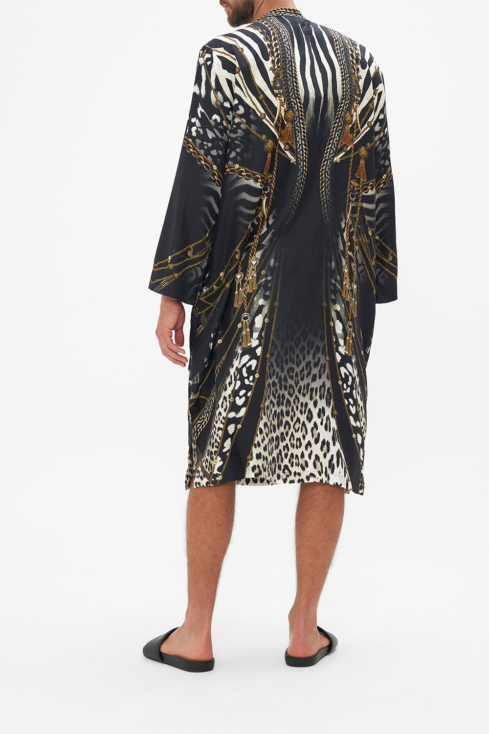 Back view of model wearing Hotel Franks by CAMILLA mens black silk kaftan in Untamed Royalty Print