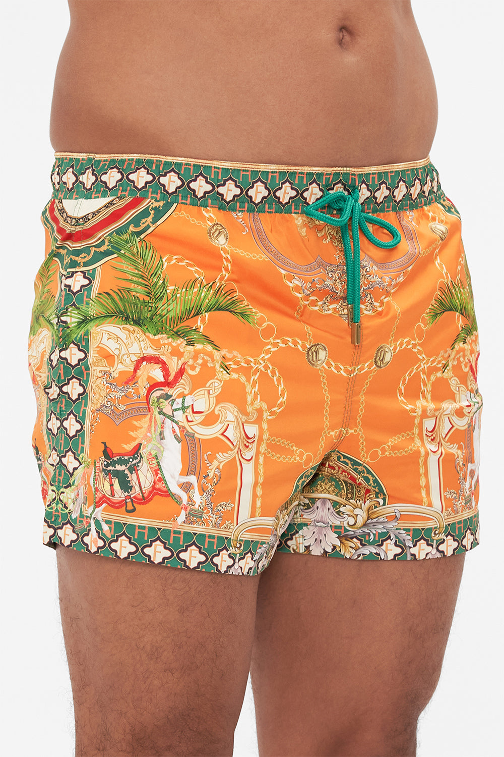Detail view of model wearing Hotel Franks by CAMILLA silk mens short boardshorts in orange Dancing With The Bulls print