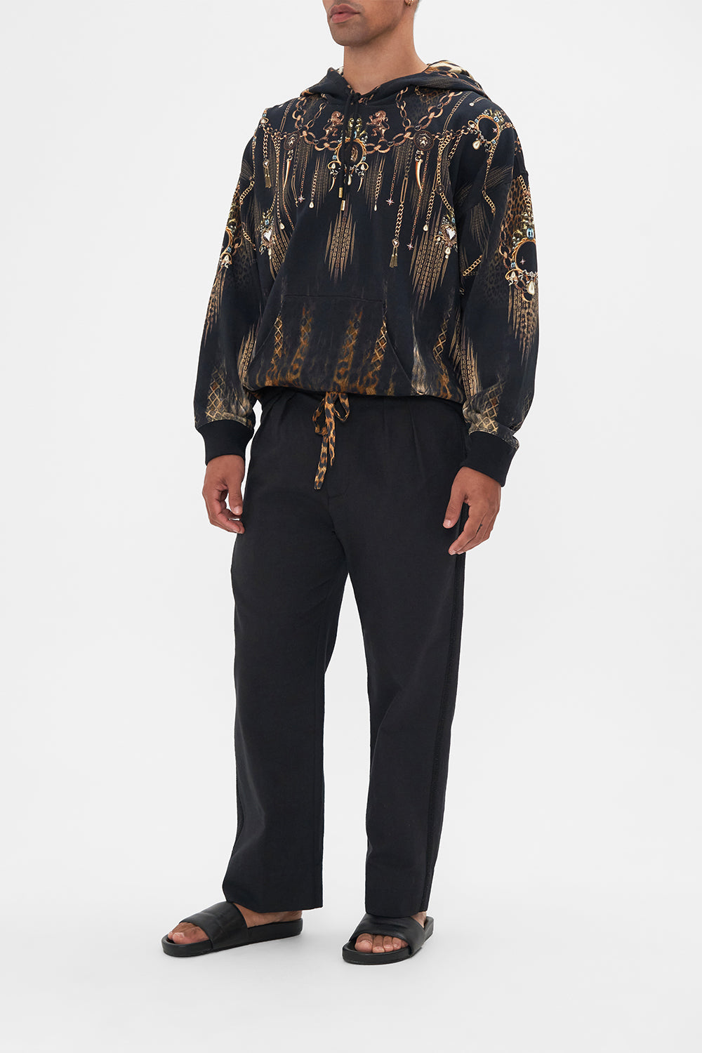 Side view of model wearing Hotel Franks by CAMILLA mens black pleat front pants Jungle Dreaming