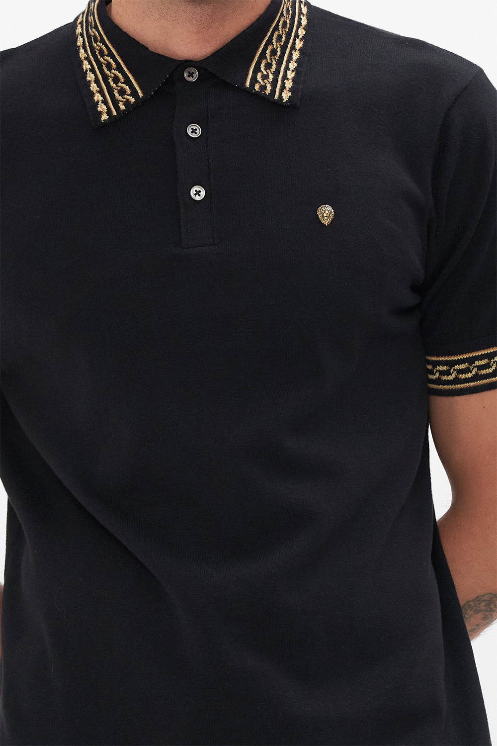 Side view of model wearing Hotel Franks by CAMILLA mens black polo shirt in Tether Me Not print