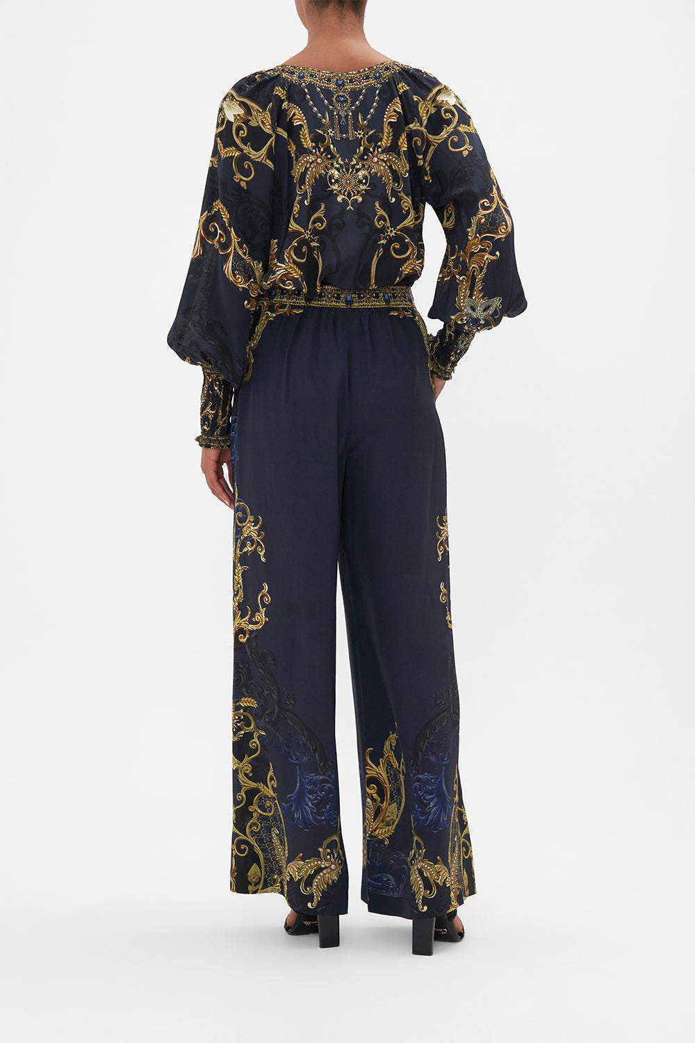 Back view model wearing of CAMILLA silk pants in Moonlight Melodies print