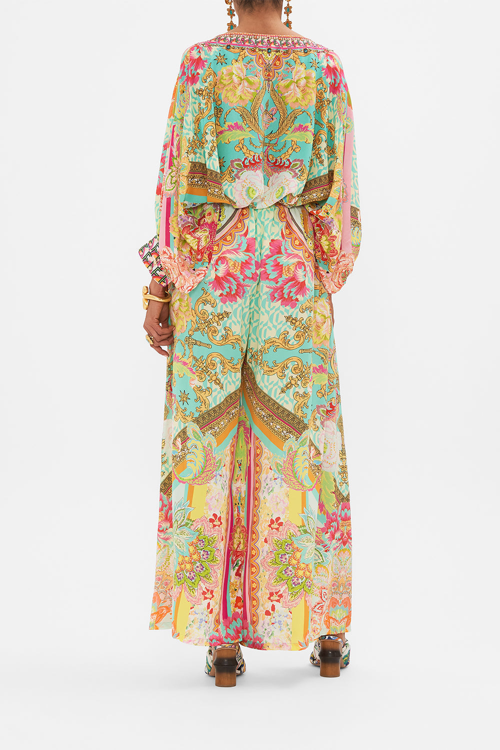 Back view of model wearing CAMILLA silk tuck front pant in An Italian Welcome print