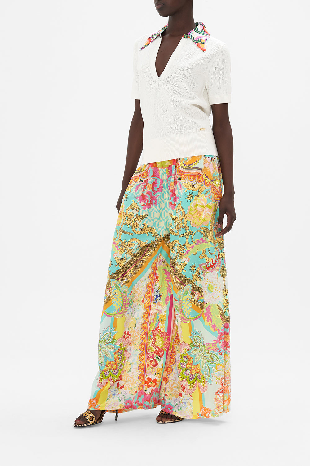 Side view of model wearing CAMILLA white knit polo top in An Italian Welcome print