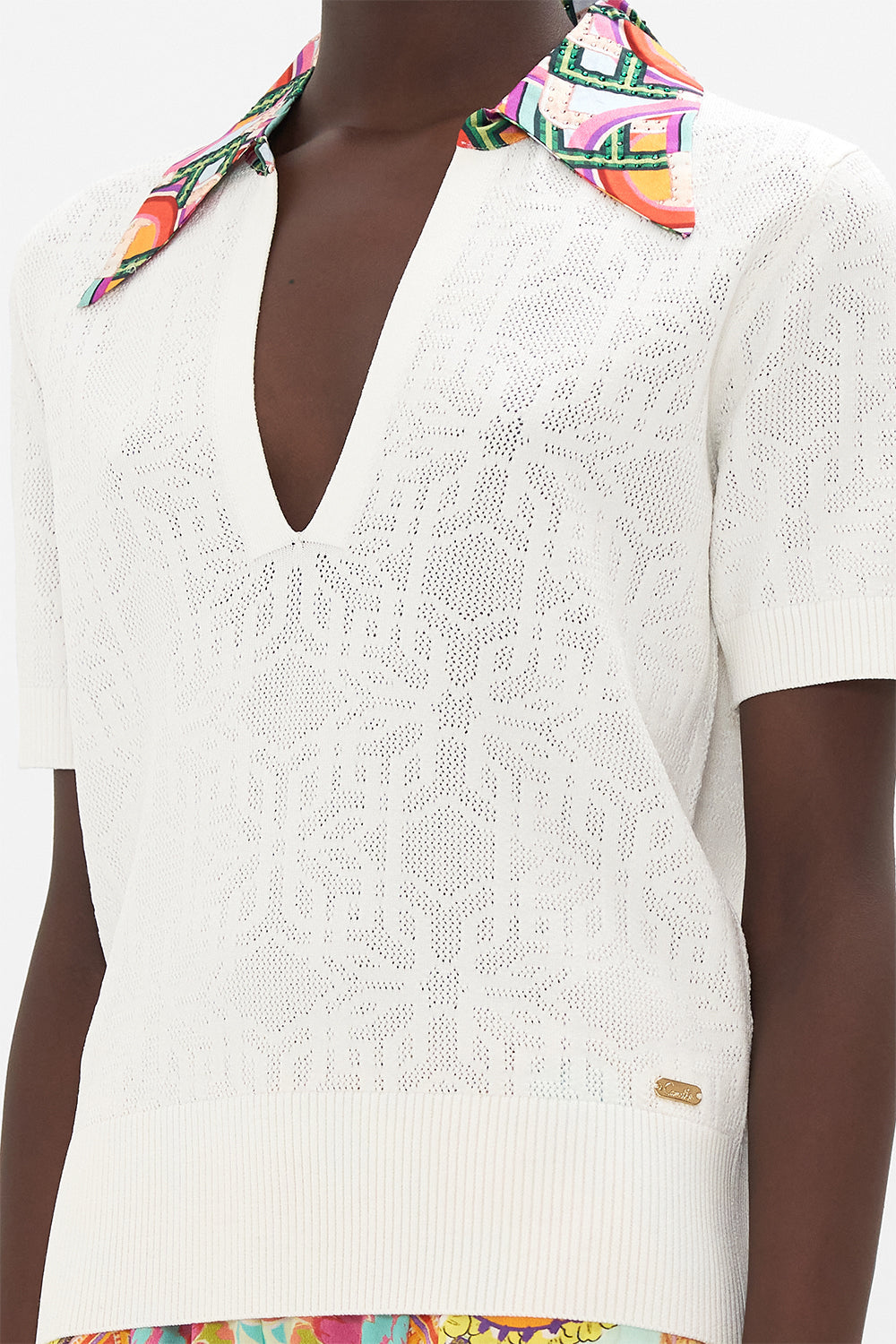 Detail view of model wearing CAMILLA white knit polo top in An Italian Welcome print