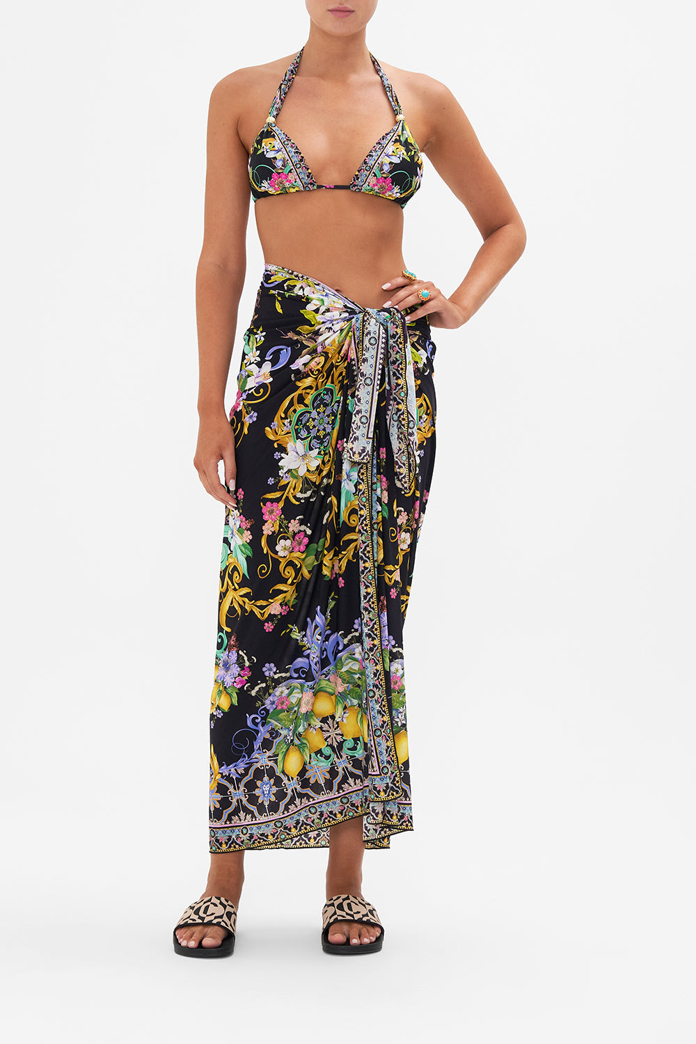 Front view of model wearing CAMILLA resortwear black floral print sarong in Meet Me In Marchesa print
