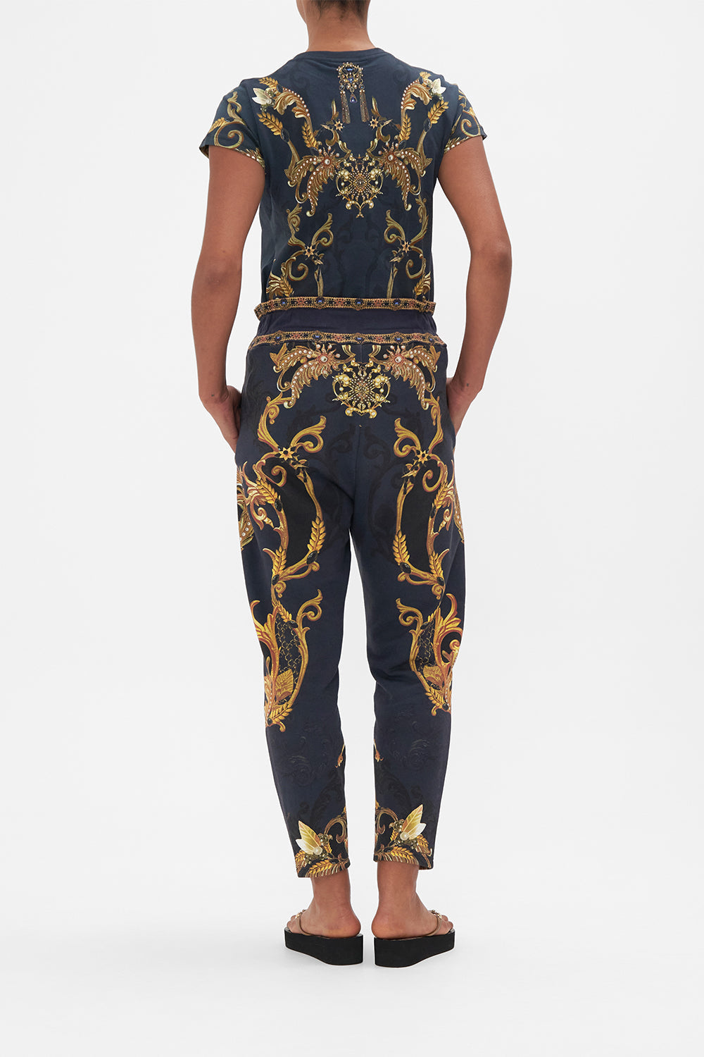 Back view of model wearing CAMILLA trackpants in Moonlight Melodies print