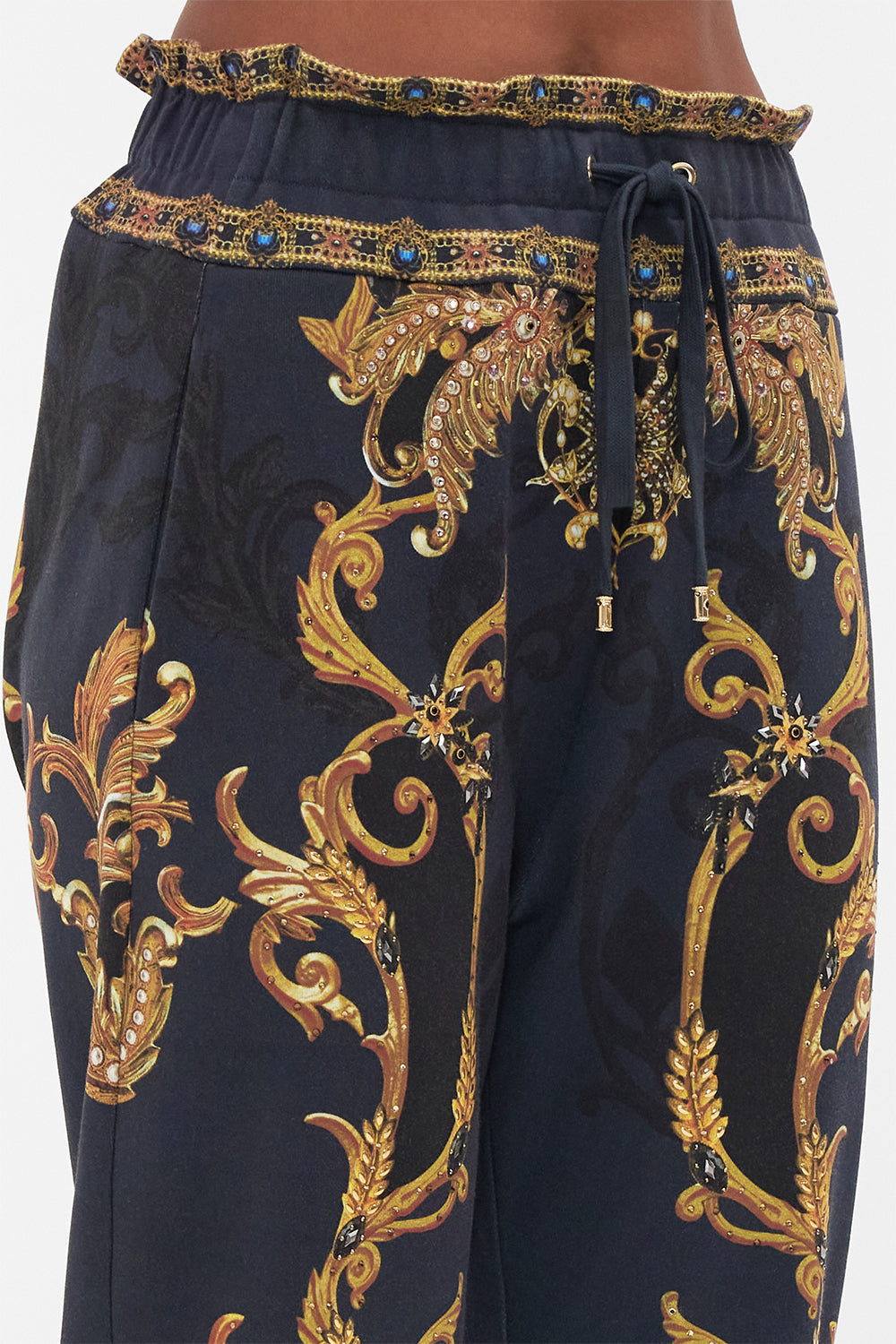 Detail view of model wearing CAMILLA trackpants in Moonlight Melodies print