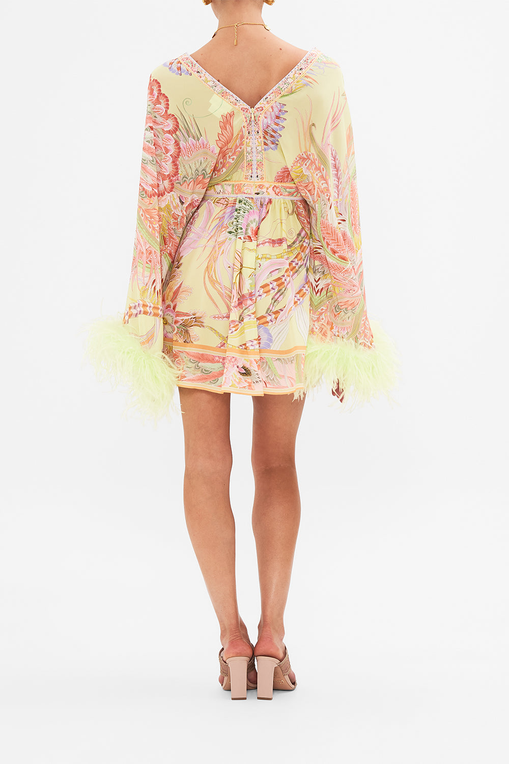 Back view of model wearing CAMILLA silk kimono mini dress with feathers in Cosmic Tuscan print