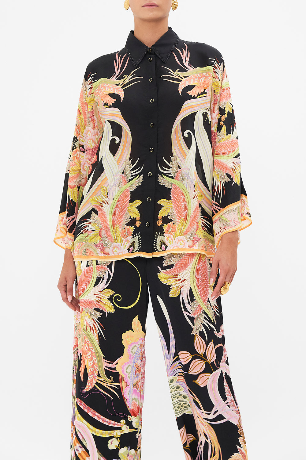 Crop view of model wearing CAMILLA silk blouse in Lady Of The Moon print