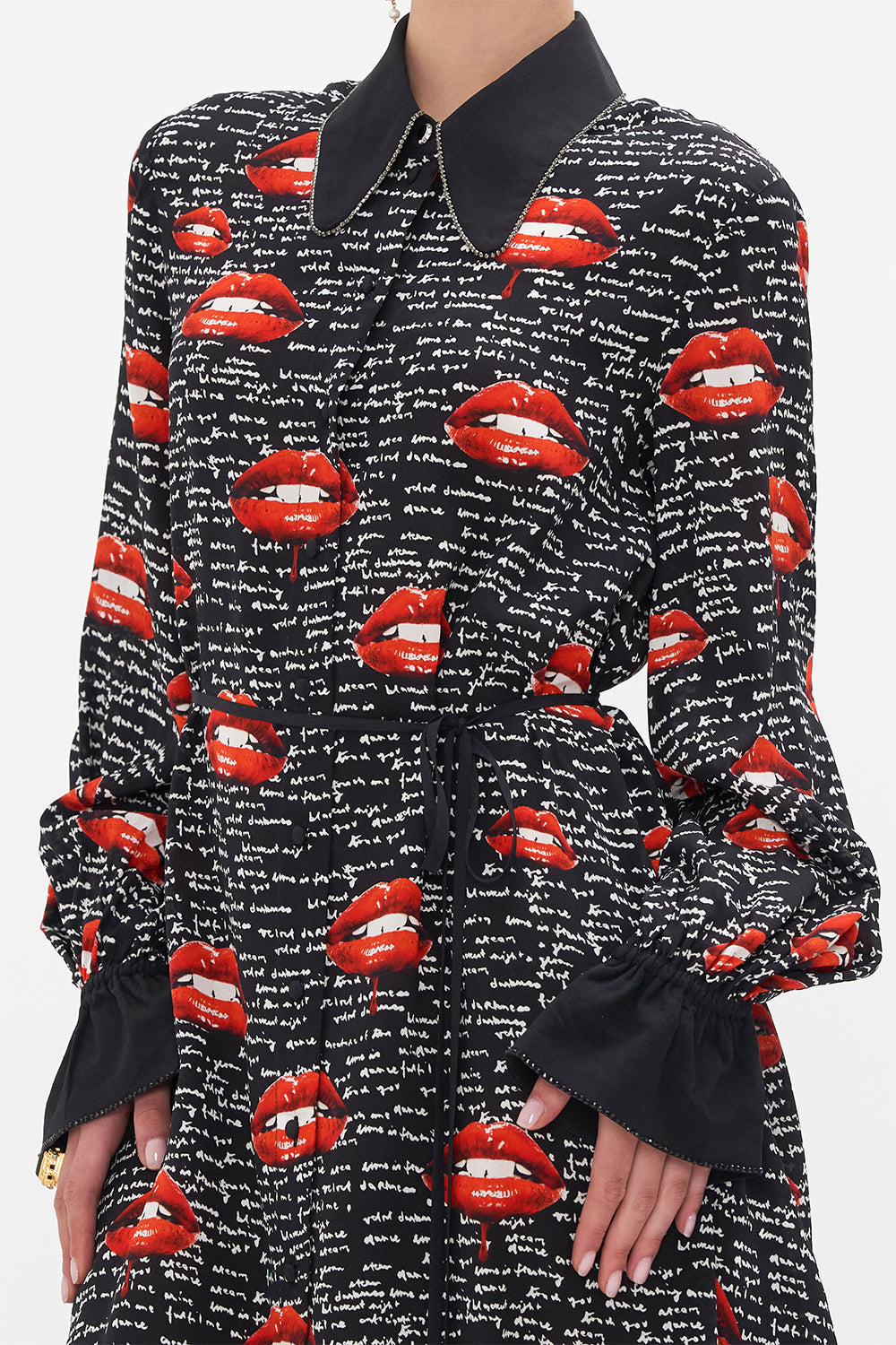 Detail view of model wearing CAMILLA black silk shirt dress in Chaos Magic print