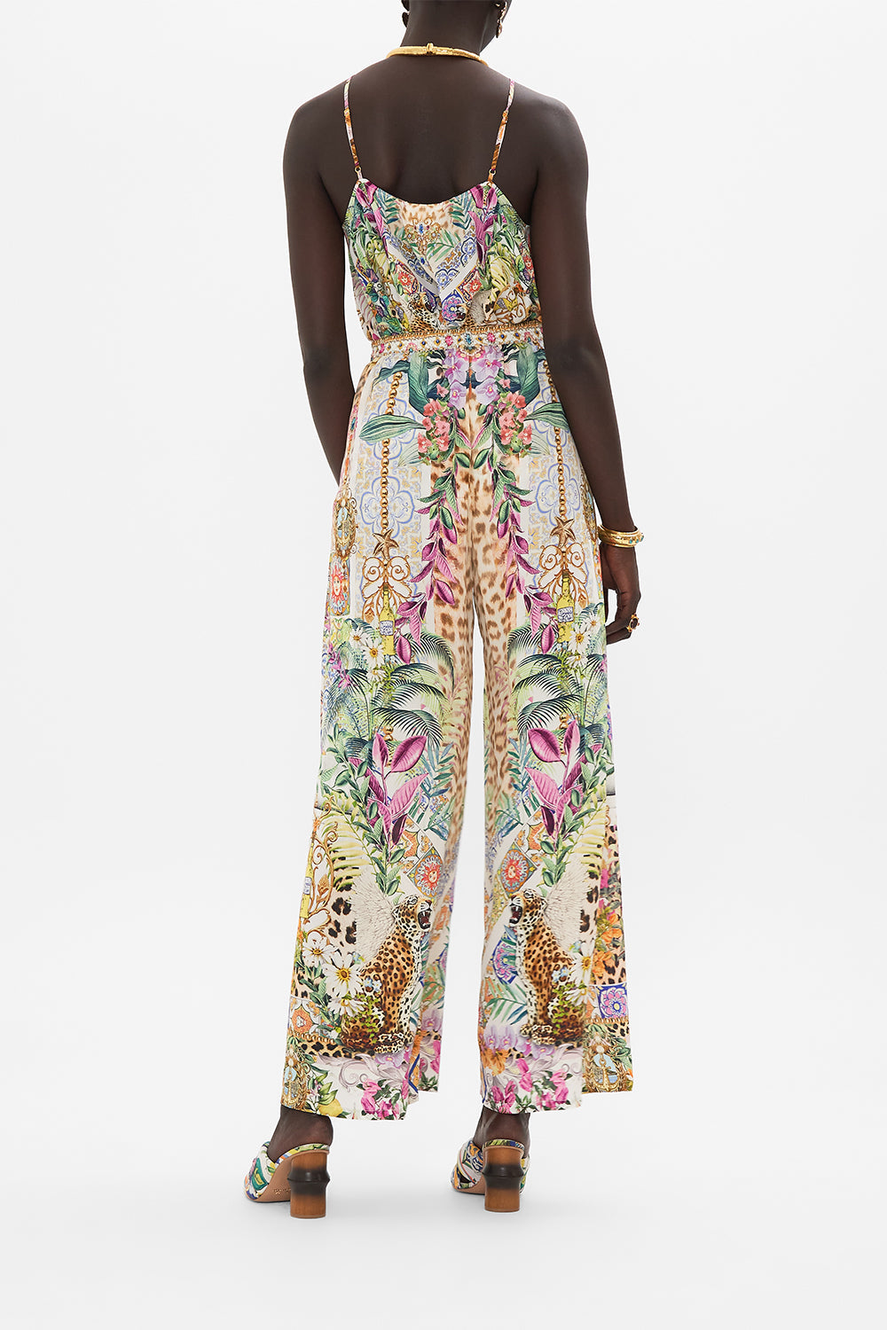 Back view of model wearing CAMILLA floral silk pants in Flowers Of Neptune print