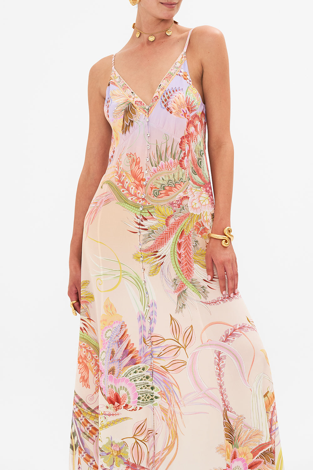 Crop view of model wearing CAMILLA button through silk dress in Cosmic Tuscan print