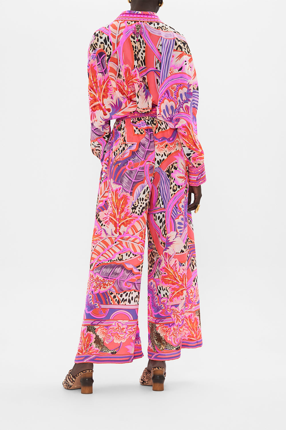 Back view of model wearing CAMILLA silk pants in Viola Vintage print