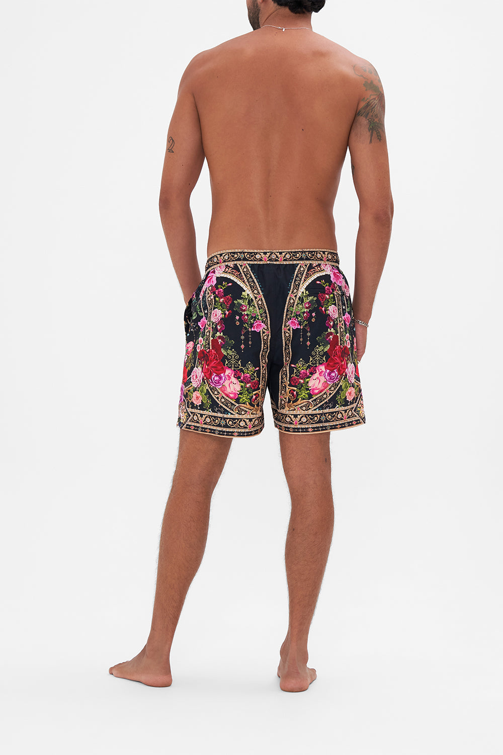 Back view of model wearing Hotel Franks by CAMILLA mens boardshorts in Reservation For Love print