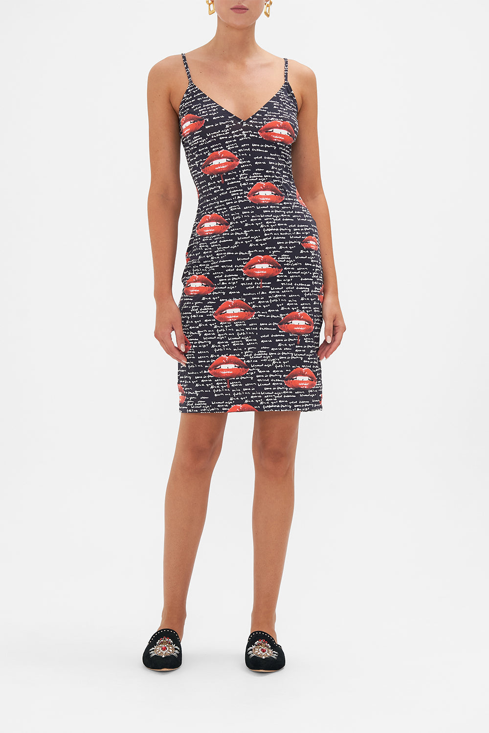 Front view of model wearing CAMILLA black slip dress in Chaos Magic print