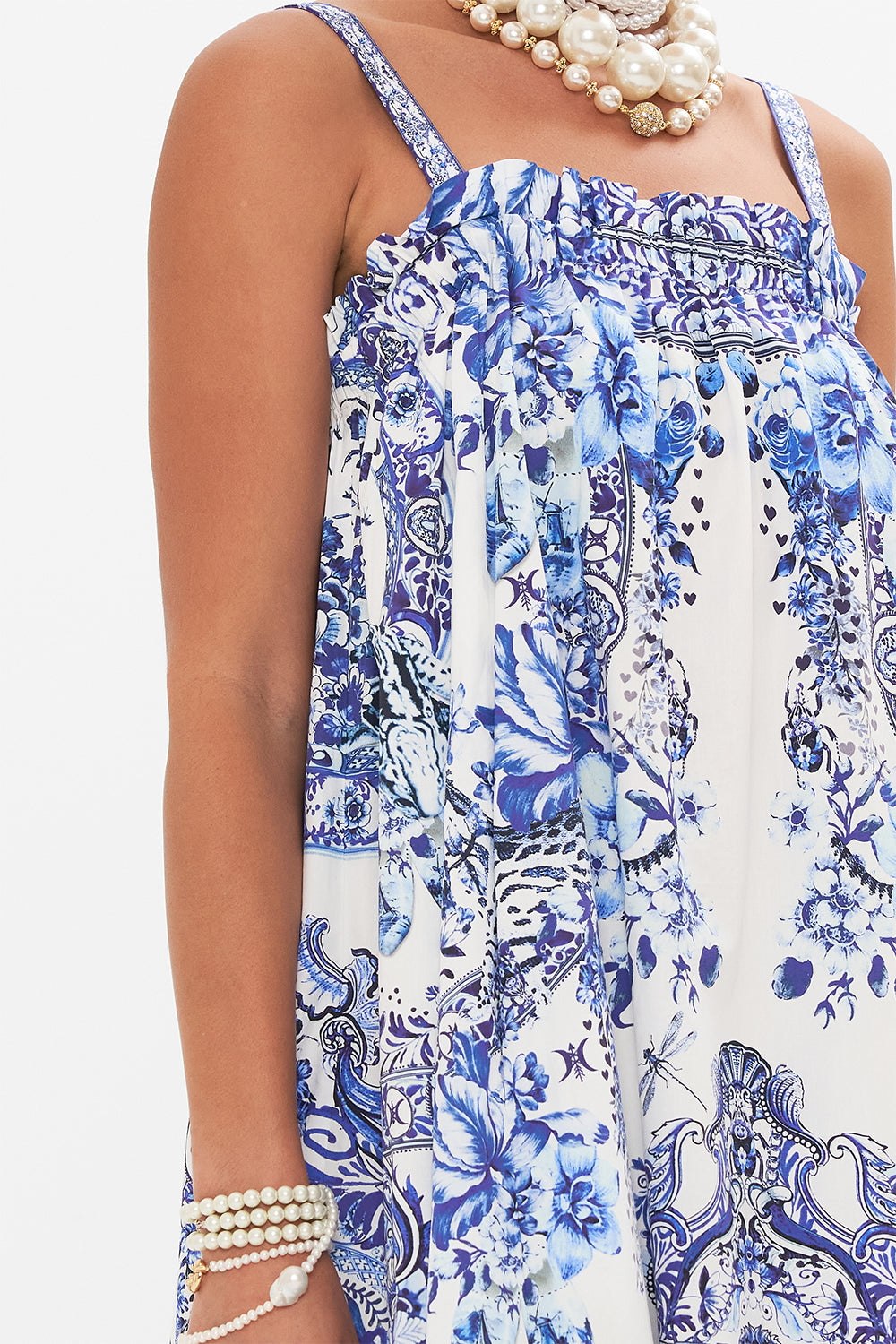 Detail view of model wearing CAMILLA blue and white sun dress in Glaze and Graze print