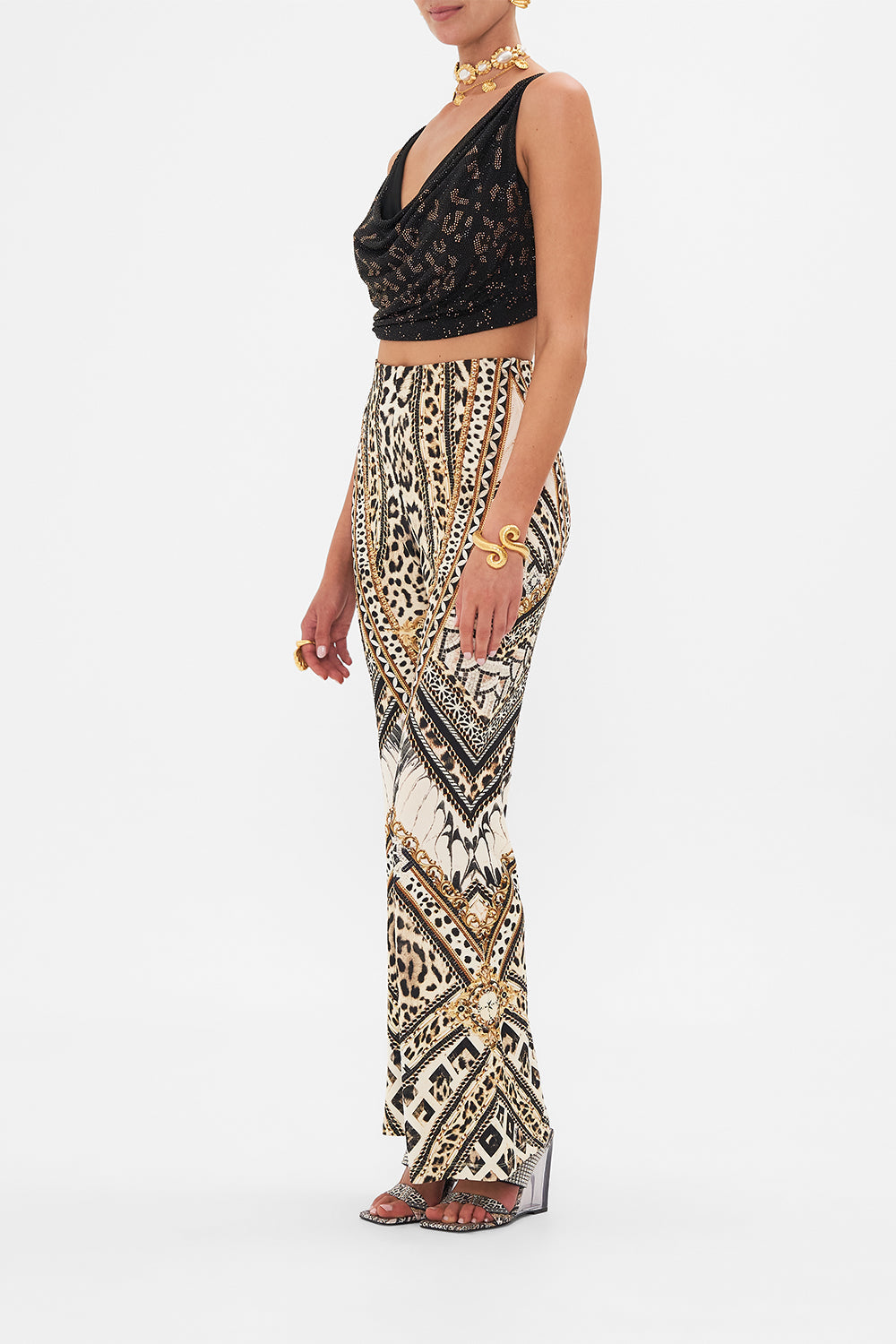 Side view of model wearing CAMILLA black halter top in Mosaic Muse