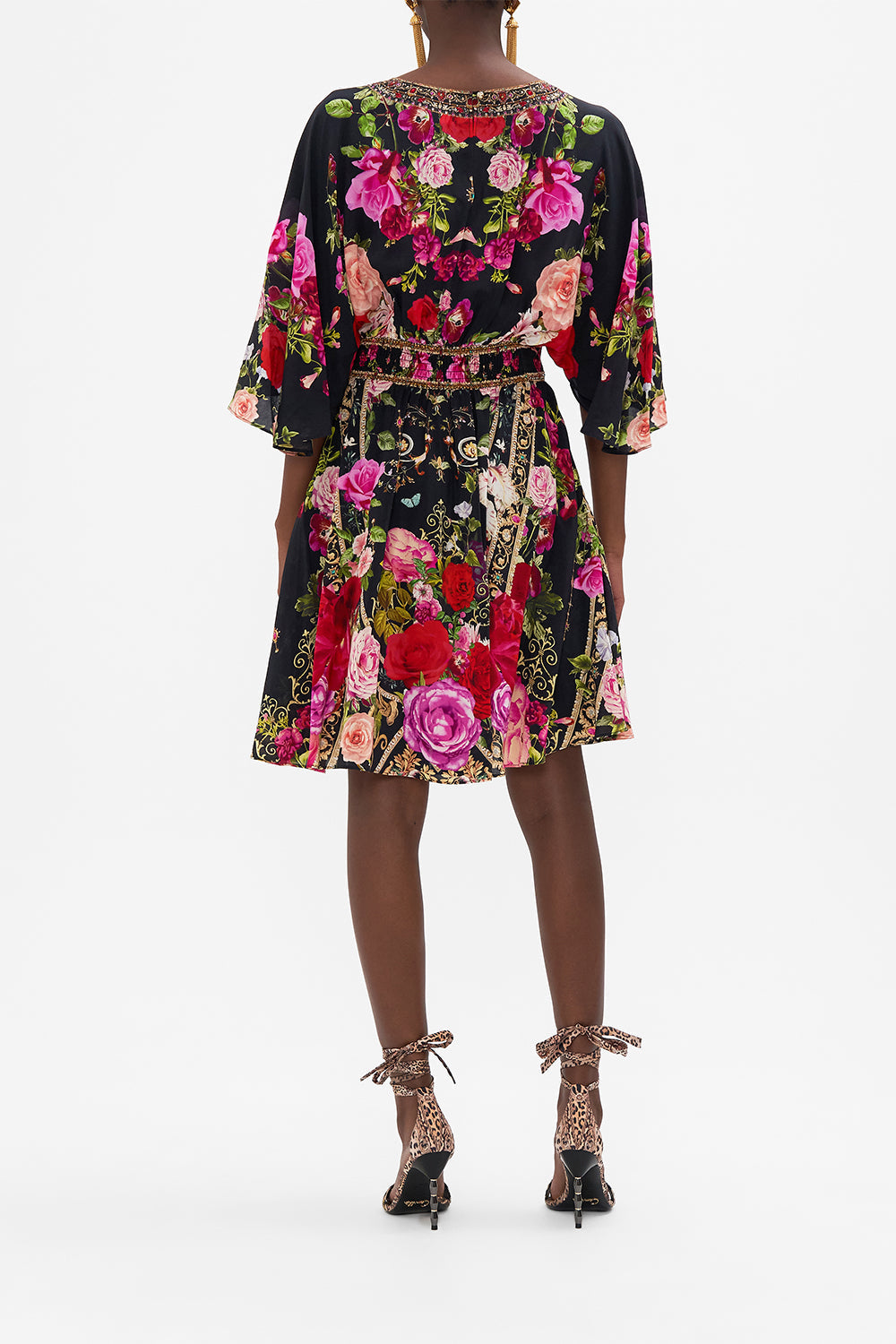 Back view of model wearing CAMILLAdesigner mini dress in Reservation for Love print