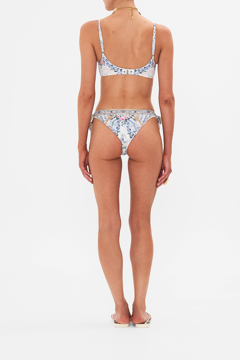 Back view of model wearing CAMILLA silk pants in Season Odf The Siren print