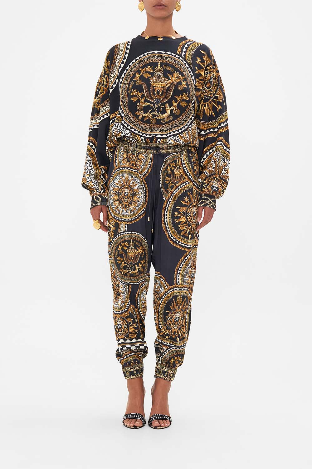 Front view of model wearing CAMILLA printed track pants in Duomo Kaleido print