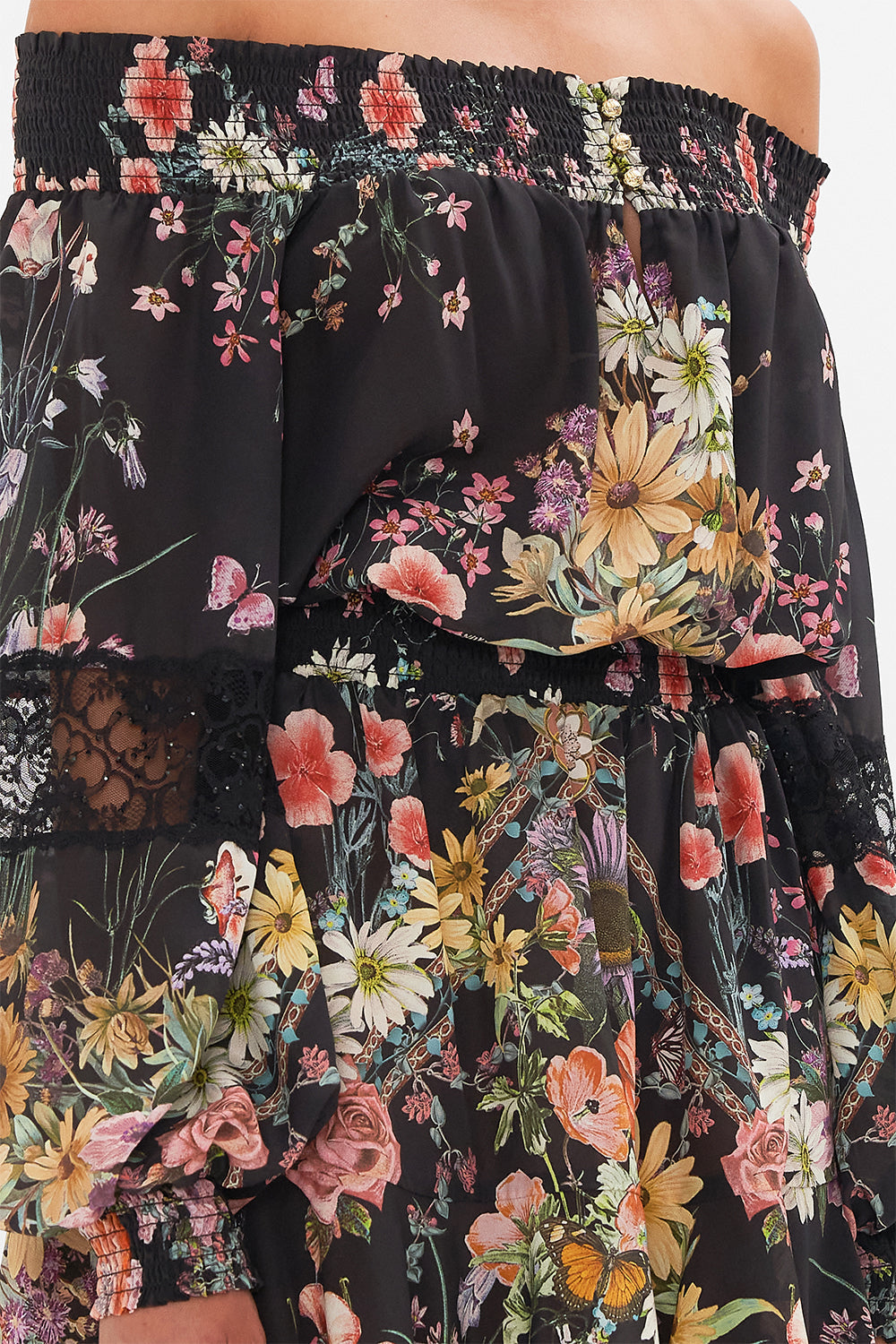 Detail view of model wearing CAMILLA off the shoulder mini dress in Letters From A Vineyard print