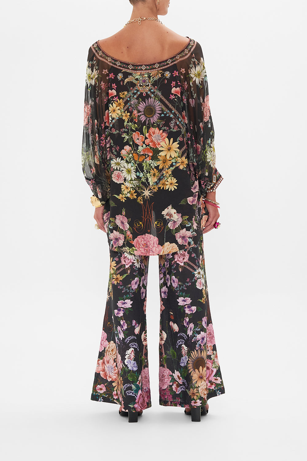 Back view of model wearing CAMILLA silk blouse in Letters From A Vineyard print