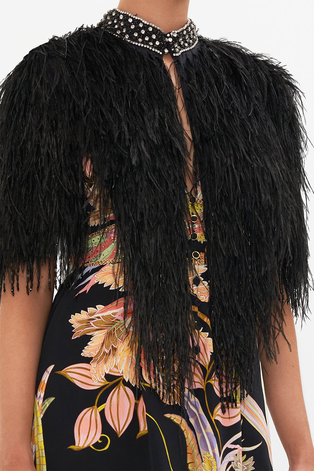 Detail view of model wearing CAMILLA beaded feather gilet in Lady of The Moon print