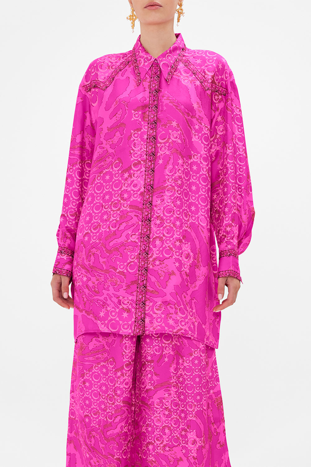 Detail view of model wearing CAMILLA silk shirt in neon Song Of Sacrifice print