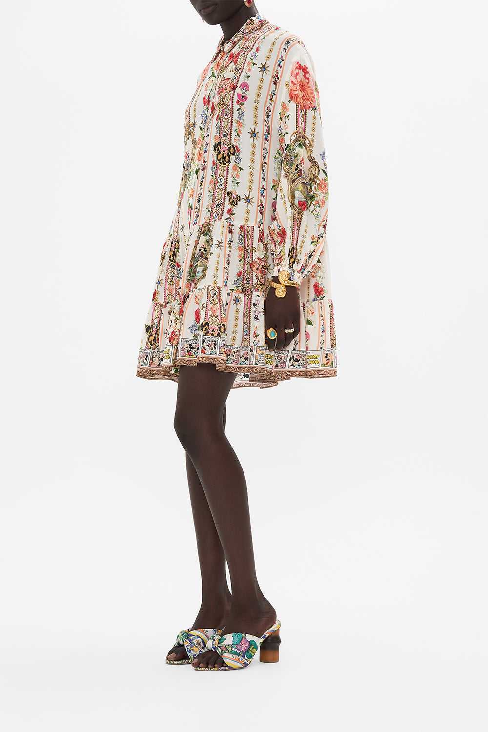 Side view of model wearing Disney x CAMILLA silk shirt dress in Minnie Magic Forever print