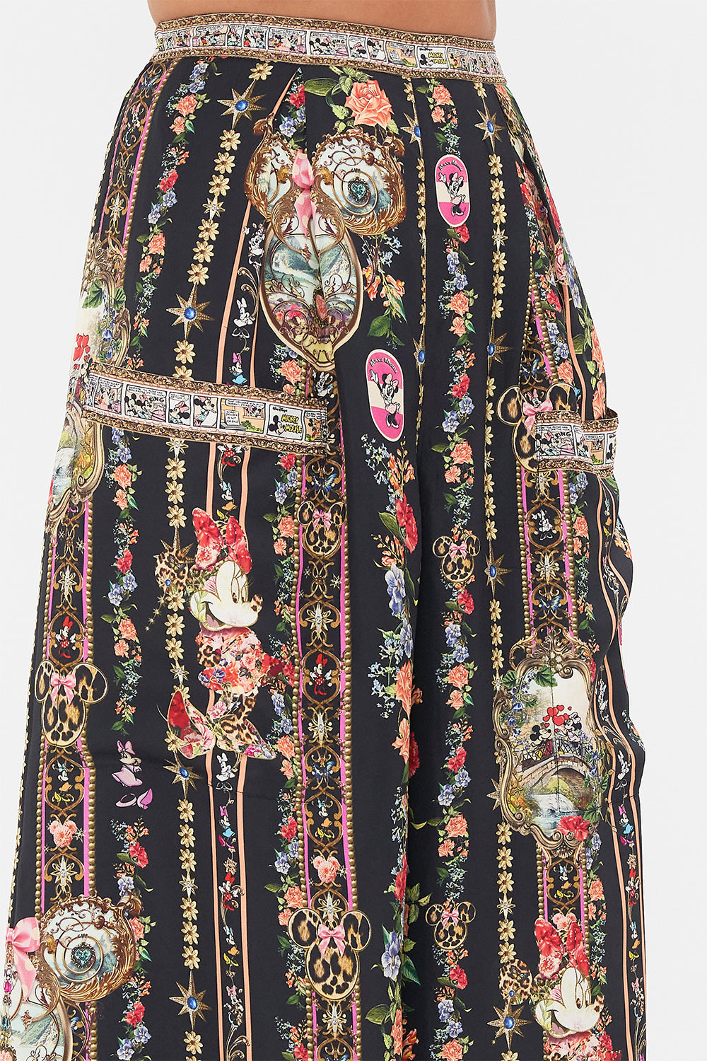 Detail view of model wearing Disney x CAMILLA silk pants in Midnight At Minnies print