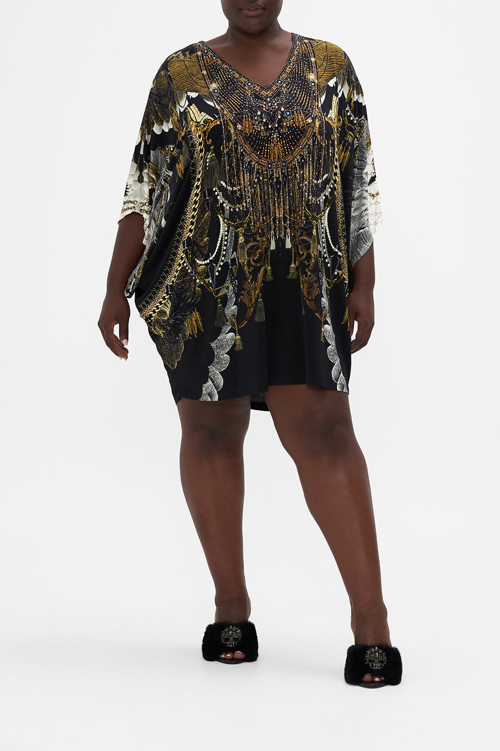 Front view of curvy model wearing CAMILLA Plus size jersey tunic dress in Ravin Raven print