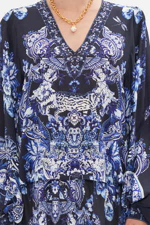 Crop view of model wearing CAMILLA silk blouse in Delft Dynasty print