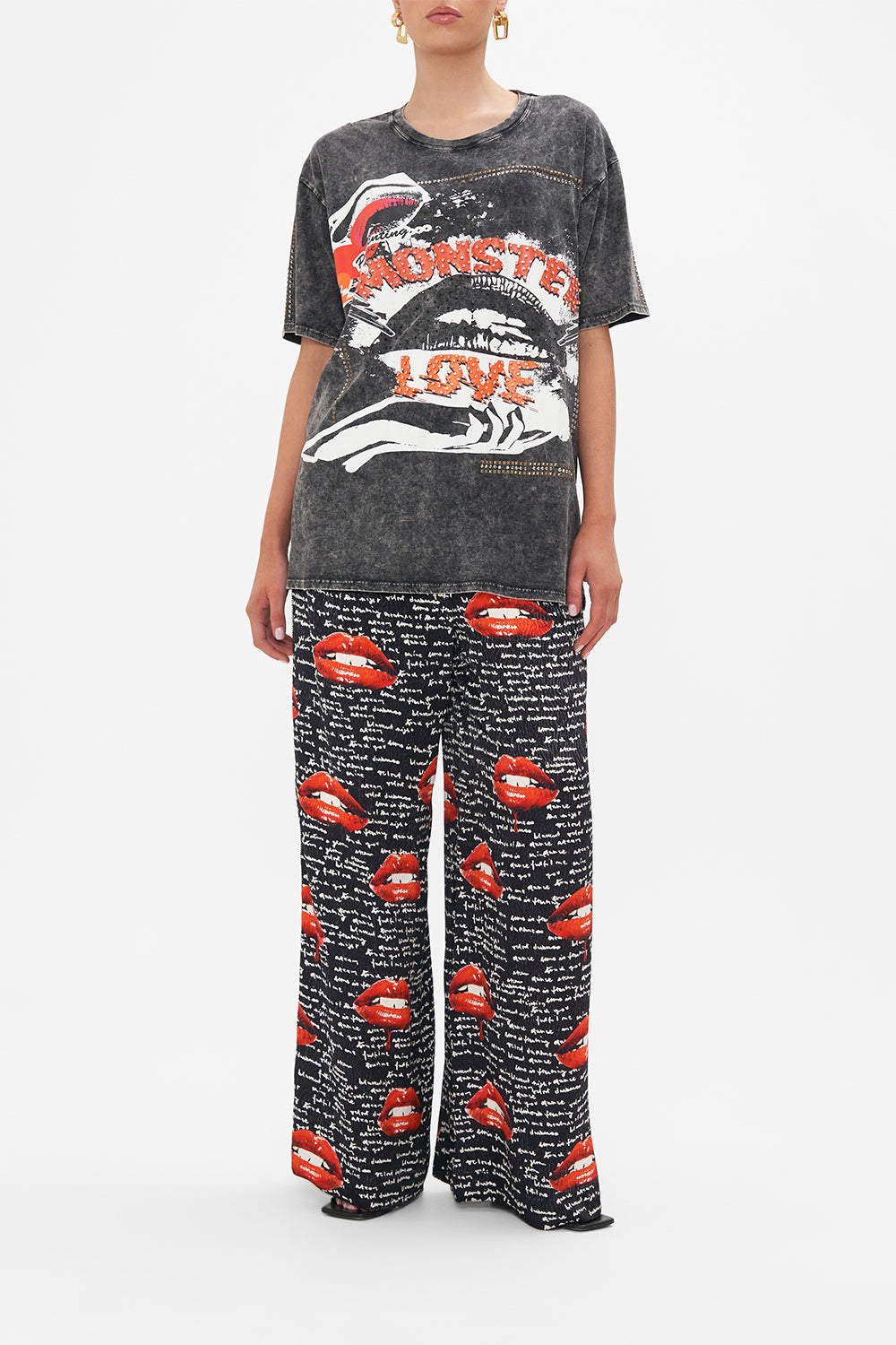 Front view of model wearing CAMILLA black acid wash graphic tee in Chaos Magic print