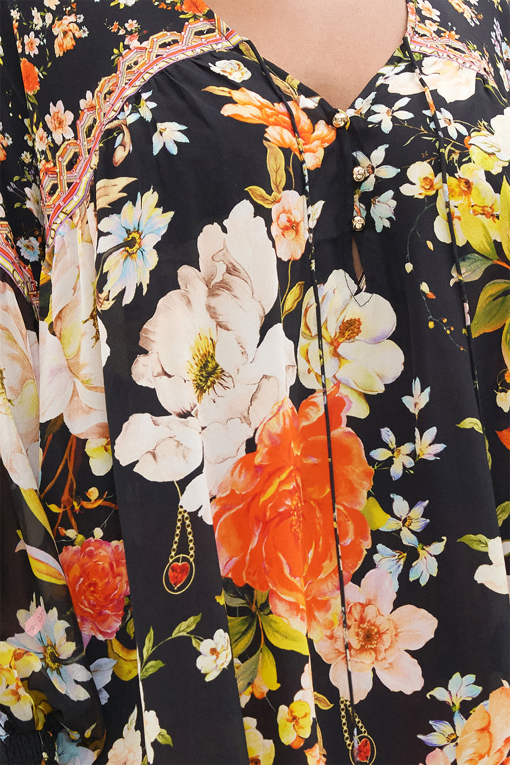 Detail view of model wearing CAMILLA silk blouse in the Secret History print