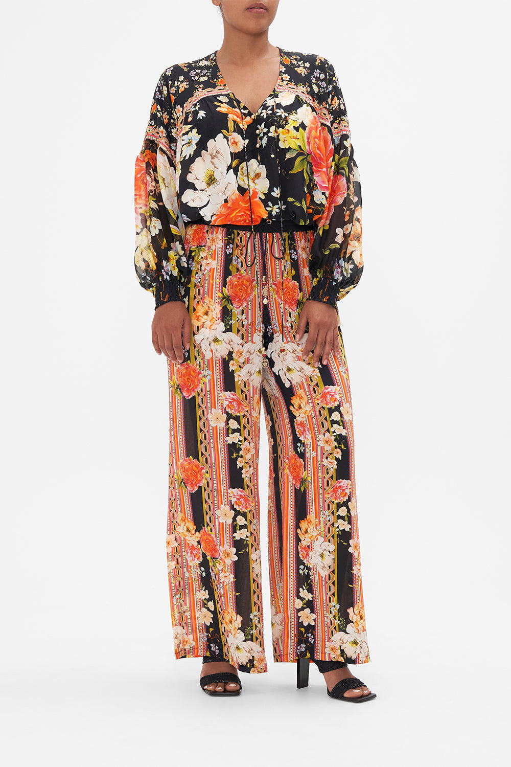 Front view of model wearing CAMILLA silk blouse in the Secret History print